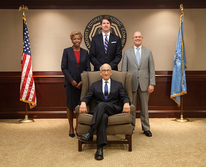 Photo showing the Fiscal Year 2014 Commissioners. Front row: Timothy G. Massad, Chairman.  Back row from left to right; Sharon Y. Bowen, Commissioner;  Mark P. Wetjen, Commissioner; J. Christopher Giancarlo, Commissioner. Photo by CFTC.